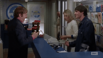 Group Standing In Front Of A & MC Sign GIF