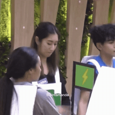 Group Standing In Front Of Aintamanda Sign GIF