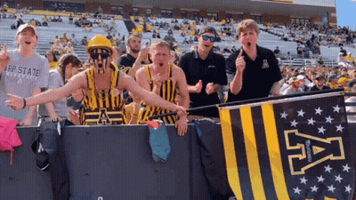 Group Standing In Front Of App State University Banner GIF