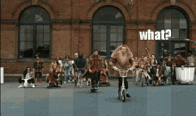 Group Standing In Front Of Brick Building Saying What GIF