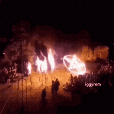 Group Standing In Front Of Burning Car GIF