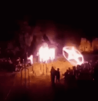 Group Standing In Front Of Burning Car GIF