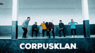 Group Standing In Front Of CorpusKlan Sign GIF