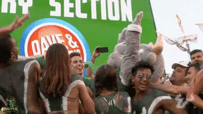 Group Standing In Front Of Dave's Sign GIF