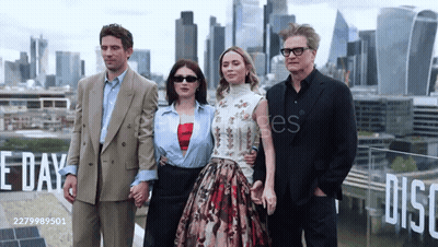 Group Standing In Front Of Disco Sign GIF