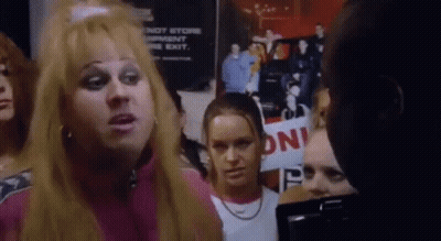 Group Standing In Front Of Do Not Store Garment On The Exit Sign GIF