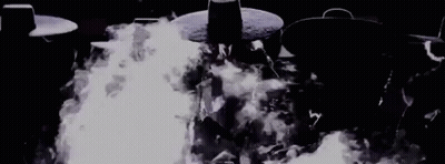 Group Standing In Front Of Fire GIF