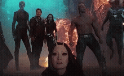 Group Standing In Front Of Fireball GIF