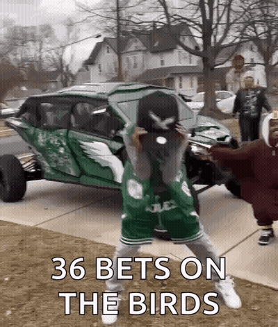 Group Standing In Front Of Green Vehicle GIF