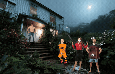 Group Standing In Front Of House With Man In CBS Shirt GIF