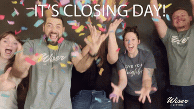 Group Standing In Front Of It's Closing Day Sign GIF