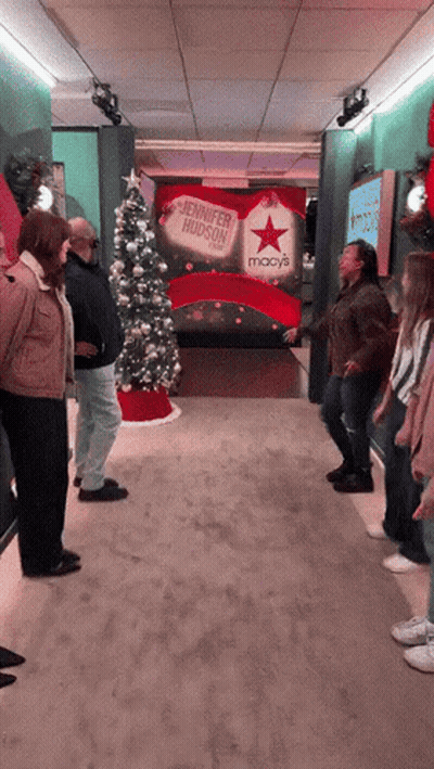 Group Standing In Front Of Jennifer Hudson Sign GIF