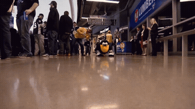 Group Standing In Front Of Lumber Sign GIF