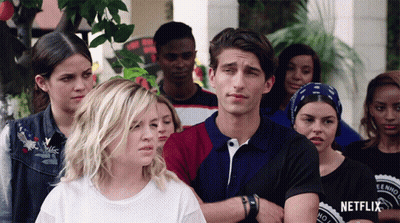 Group Standing In Front Of Netflix Sign GIF