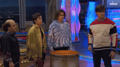 Group Standing In Front Of Nickelodeon Advertisement GIF
