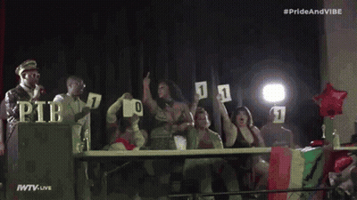 Group Standing In Front Of Pride And Vibe Sign GIF
