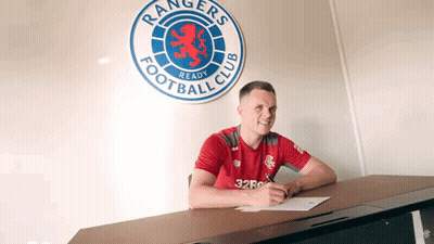 Group Standing In Front Of Rangers TV Banner GIF