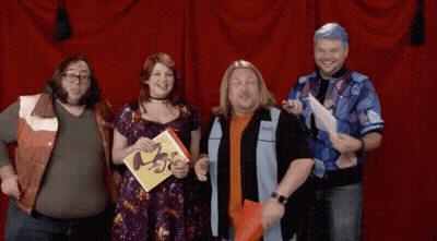 Group Standing In Front Of Red Curtain Holding ABC Book GIF