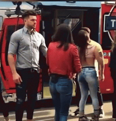 Group Standing In Front Of Red Fire Truck GIF