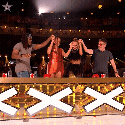 Group Standing In Front Of Sign Saying Xxx GIF