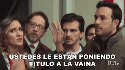Group Standing In Front Of Sign Ustedes Le Estan Poniendo Título A La Vaina GIF