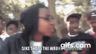 Group Standing In Front Of Sike Sign GIF