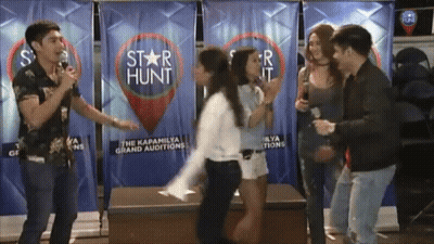 Group Standing In Front Of Star Hunt Banner GIF
