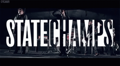Group Standing In Front Of State Champs Sign GIF