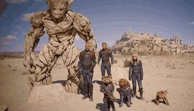 Group Standing In Front Of Statue GIF