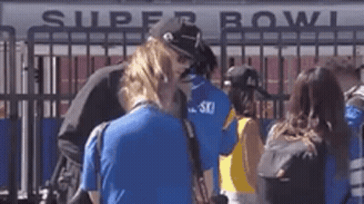 Group Standing In Front Of Super Bowl Sign GIF