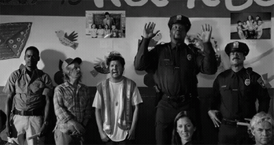 Group Standing In Front Of Wall With Pictures GIF
