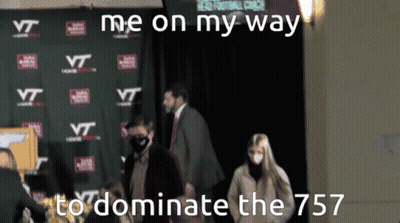 Group Standing In Front Of Wall With VT Logos GIF