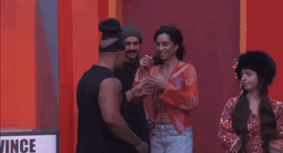 Group Standing In Front Of Wing Sign GIF
