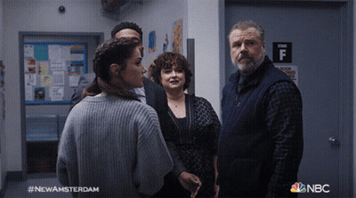 Group Standing In Hallway With Stair F Sign GIF