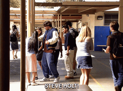 Group Standing In Hallway With Steve Holt On Table GIF