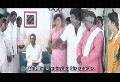 Group Standing In Room Talking About Snacks GIF