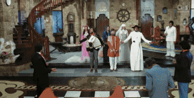 Group Standing In Room With Clock Saying Clock GIF