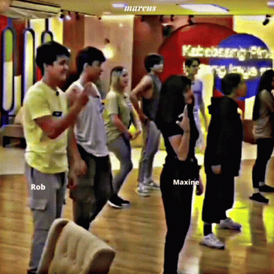 Group Standing In Room With Maxine Shirt GIF