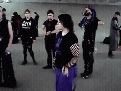 Group Standing In Room With Shirt Saying Dark GIF