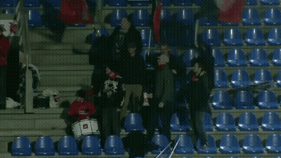 Group Standing In Stadium With Drummer Wearing Skulls Shirt GIF