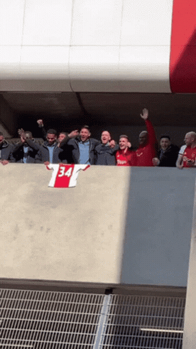 Group Standing On Balcony With 34 Shirt GIF