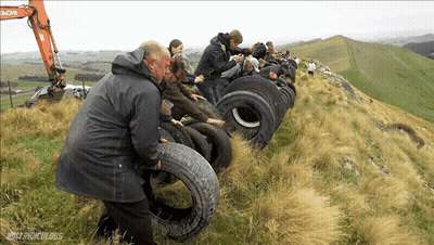 Group Standing On Hill With Hitachi Excavator GIF