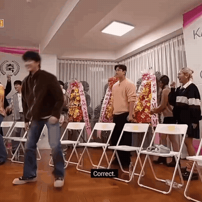 Group Standing With Folding Chairs And Correct Sign GIF