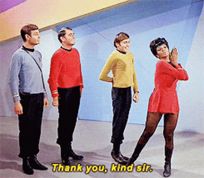 Group Standing With Woman In Red Dress Saying Thank You Kind Sir GIF