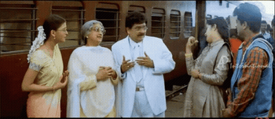 Group Talking Near Train GIF