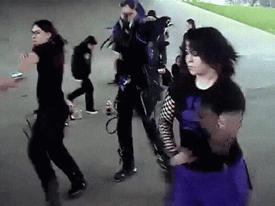 Group Walking Down Sidewalk One In Purple Skirt GIF