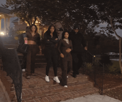 Group Walking Down Staircase In Dark Area GIF