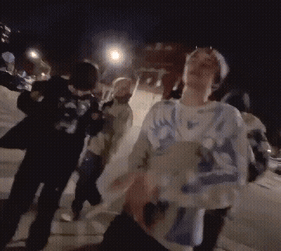 Group Walking Down Street At Night GIF