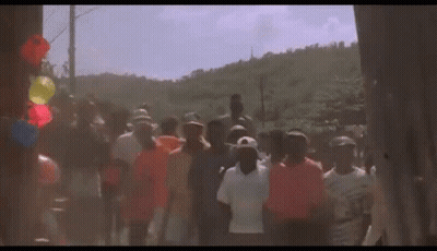 Group Walking Down Street With Balloons GIF