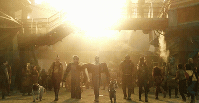 Group Walking Down Street With Bright Sun GIF